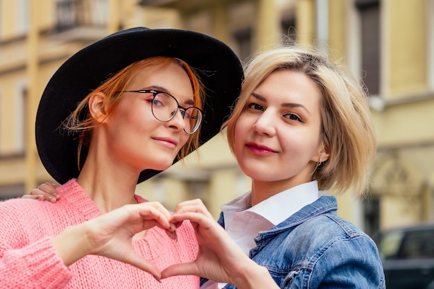 Two cheerful same sex people in love walking outdoors in Europe