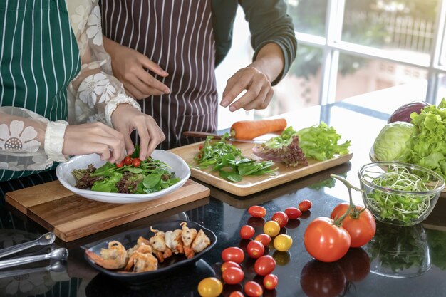 Two chefs help fry shrimp in the kitchen.