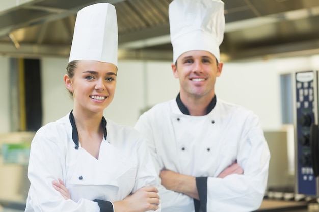 Two chefs smiling at the camera