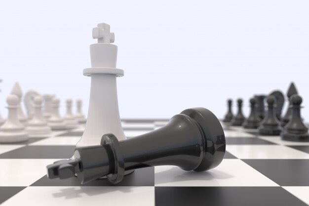 Two chess pieces on a chessboard. Black king laying down and white king standing up. 