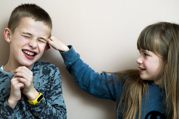 Two children boy and girl fooling around having fun together. Happy childhood concept.