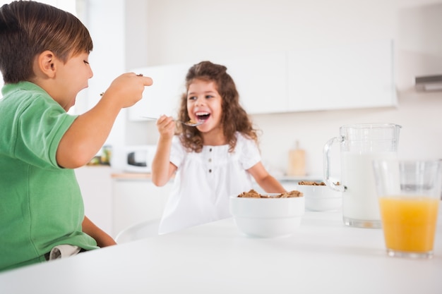 Two children eating cereal