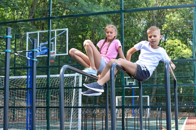 Two children, girl and boy having fun together in nature.