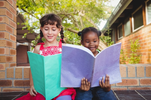 Two children holding a book