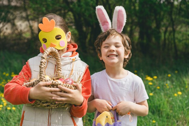 Two children hunt for Easter eggs in a spring garden Easter tradition