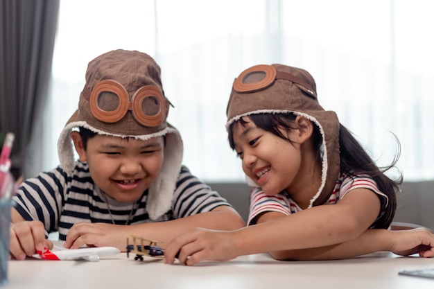 Two children with airplanes in hands