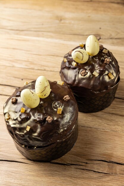 Two chocolate cakes with eggs on a wooden table