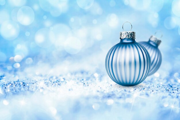 Two christmas ornaments on abstract defocus background