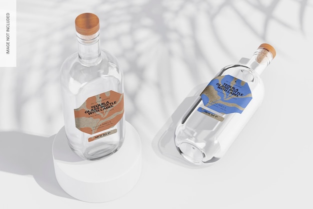 Two clear glass bottles with wooden corks