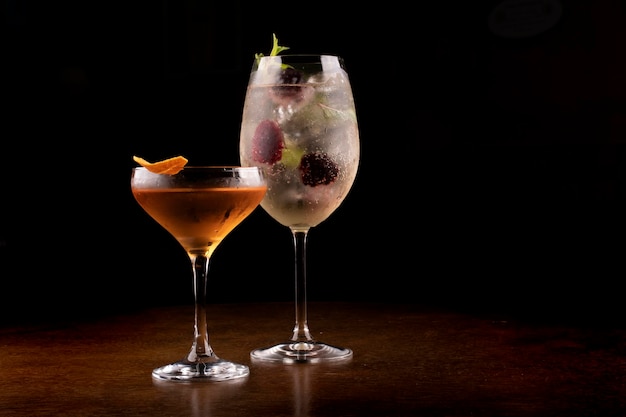 Two cocktail glasses on wooden table with front view