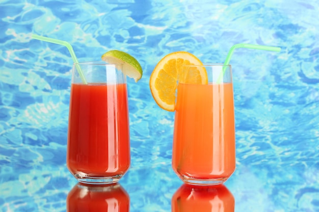 Two cocktails on blue background