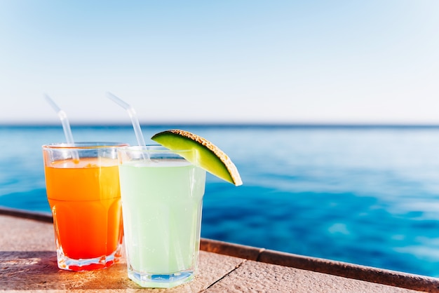 Two cocktails by the pool