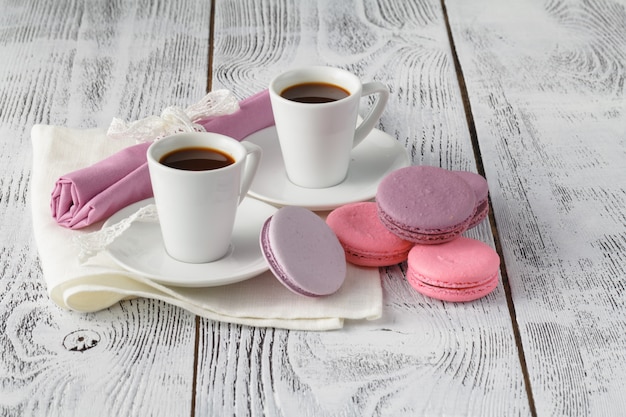 Two coffee cups on shabby chic  wooden table in cafe