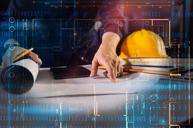 two colleagues discussing data working and tablet laptop with on on architectural project at construction site at desk in office