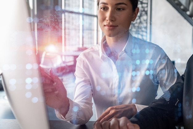 Two colleagues in formal wear working together looking for new employees to hire for international business consulting HR social media icons over modern office background