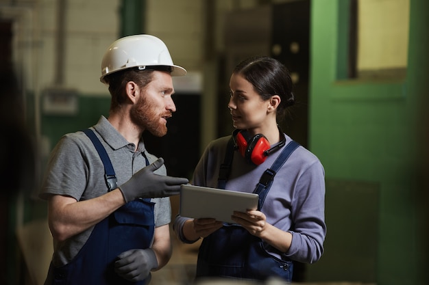 Two colleagues working in the factory