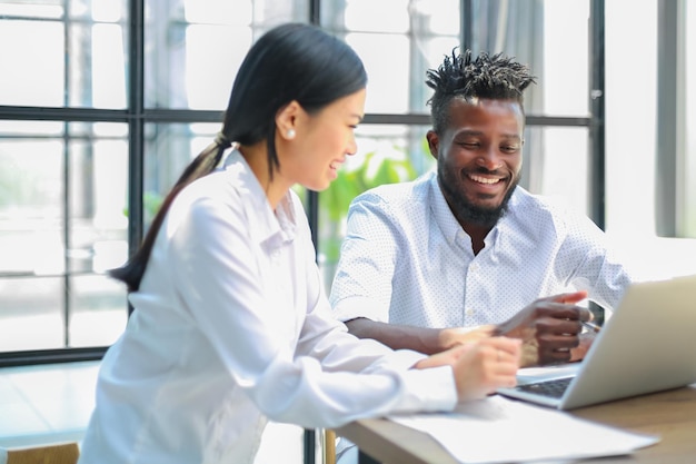 Two collegues discussing documents and other working moments in office