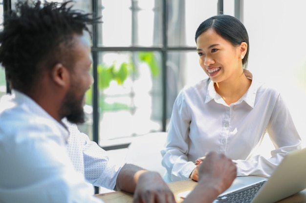 Two collegues discussing documents and other working moments in office