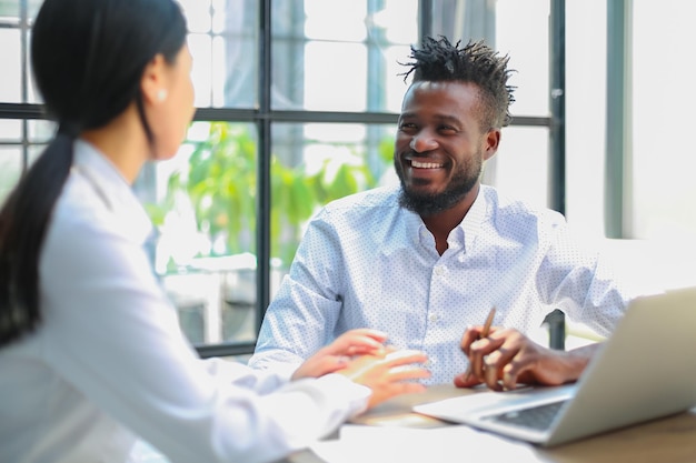 Two collegues discussing documents and other working moments in office