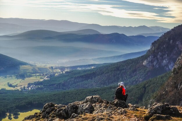 Two colorful climber sitting on a rock after the tour