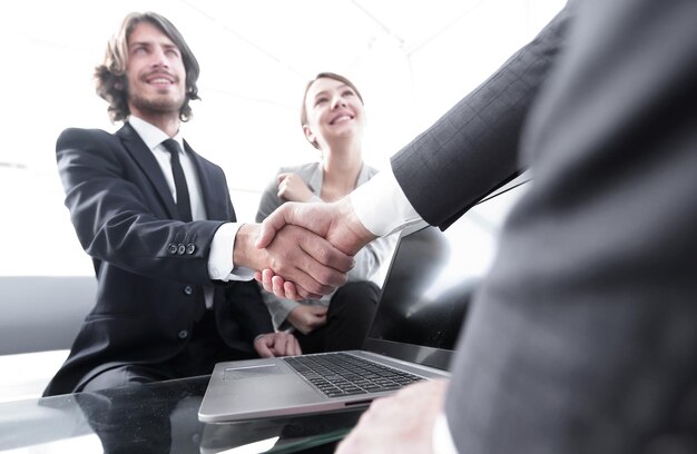 Two confidence businessman shaking hands closeup