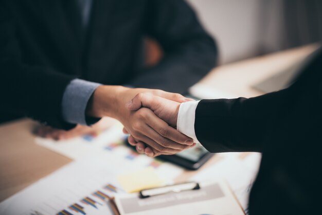 Two confident business man shaking hands during a meeting in the office