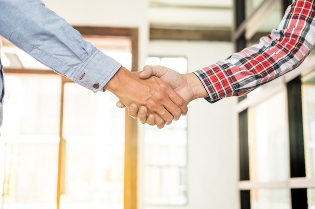 Two confident business man shaking hands 