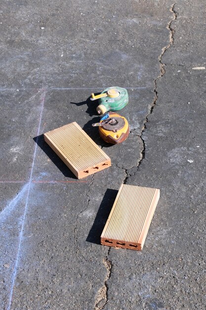 Two construction drawings and bricks on a construction site