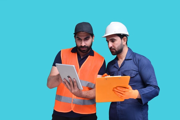 two construction worker holding tab and looking it indian pakistani model