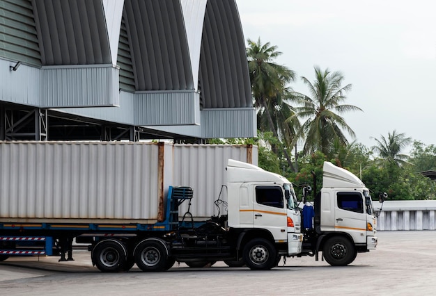 Two container trailer is loading cargo at warehouse.