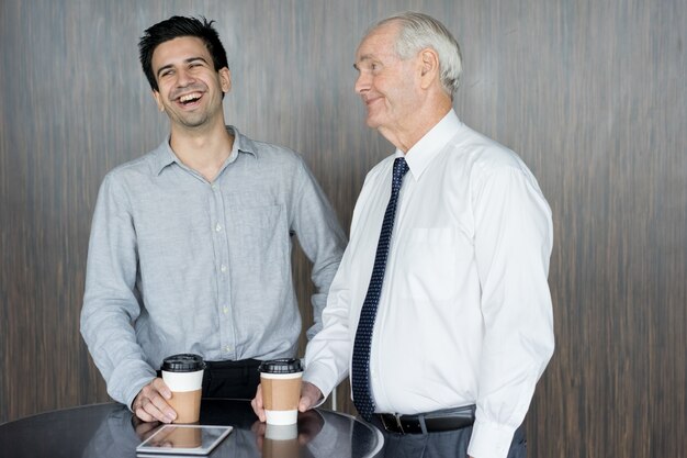 Two Content Office Employees Drinking Coffee