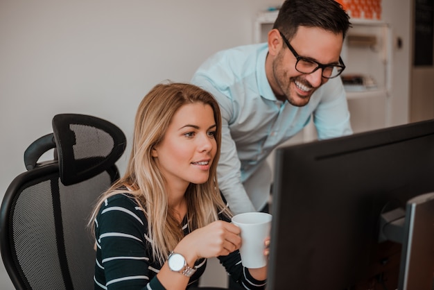 Two corporate business colleagues working together in office.