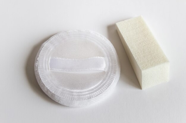 Two cosmetic sponges pad for powder cream foundation facial application on white surface