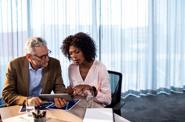 Two coworkers working on a tablet computer