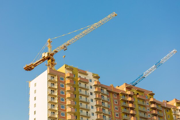 Two cranes on the construction of a multistorey residential building