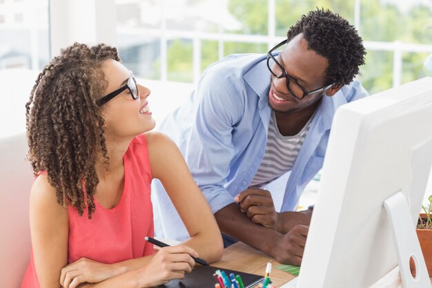 Two creative business colleagues talking together