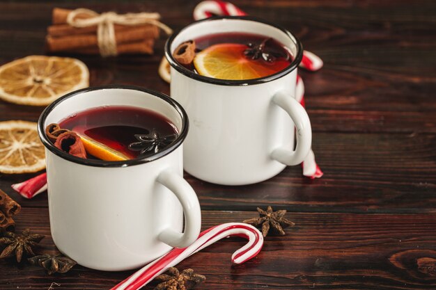 Two cups of Christmas mulled wine on a wooden table