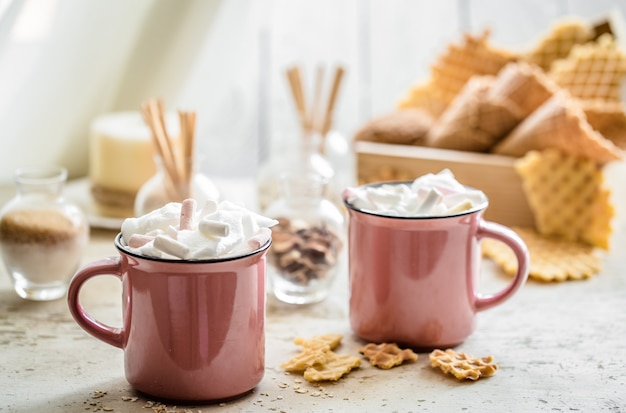 two cups of cocoa with marshmallows