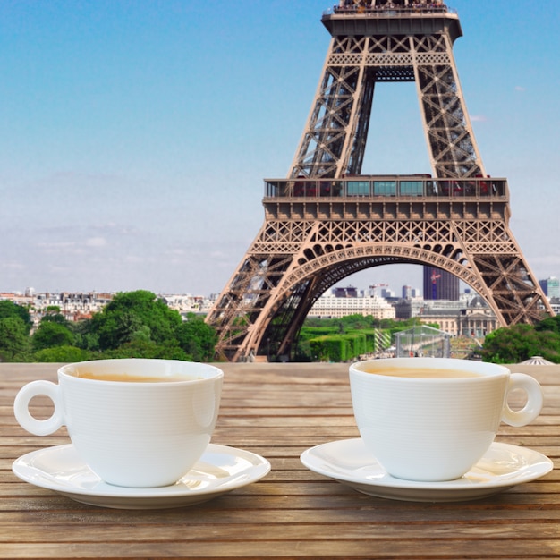 Two cups of coffee in Paris cafe with view of Eiffel Tower