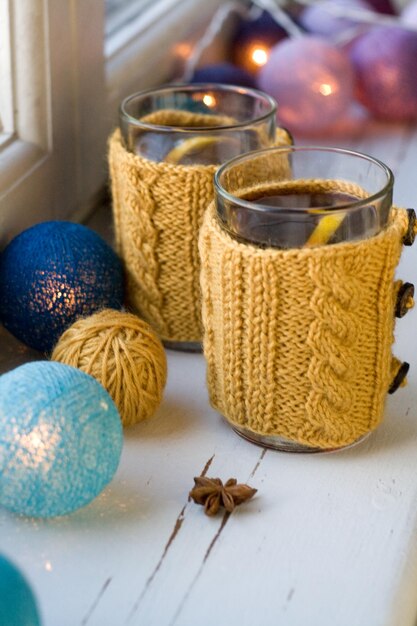 Two cups of delicious tea in yellow knitted sweater