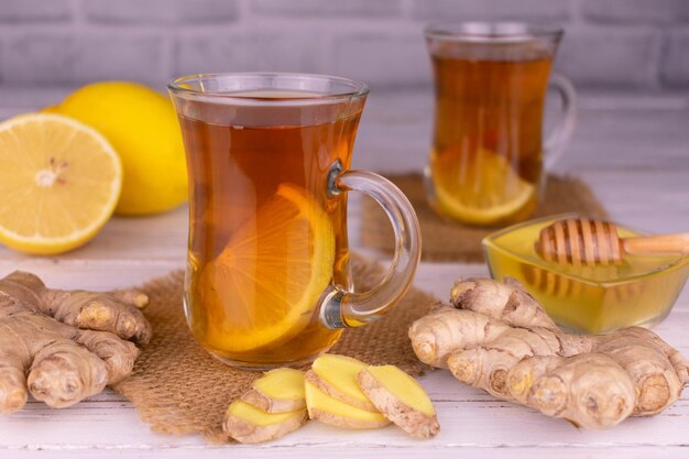 Two cups of ginger tea with honey and lemon