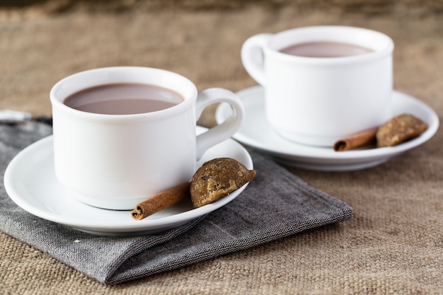 Two cups of hot chocolate on burlap