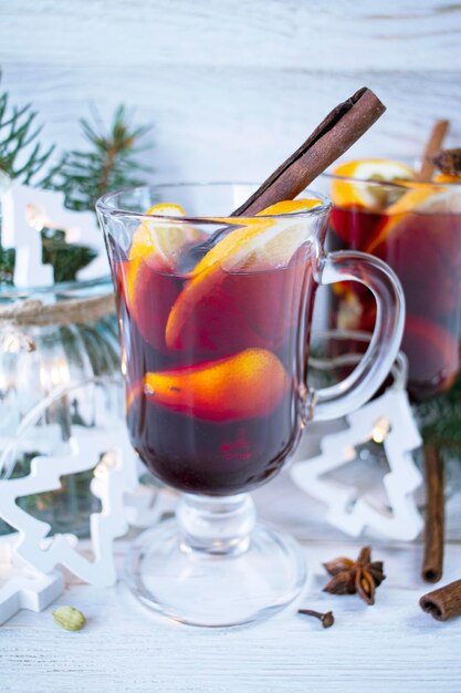 Two cups of hot chocolate with marshmallows and Christmas decorations illumination