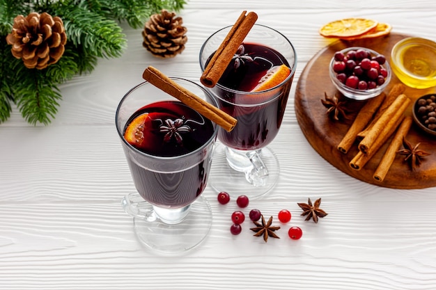 Two cups of mulled wine, spices and dry citrus fruits warming Christmas drink