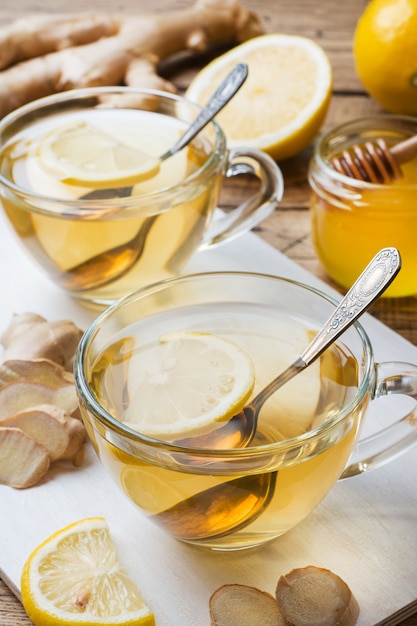 Two cups of natural herbal tea ginger lemon and honey