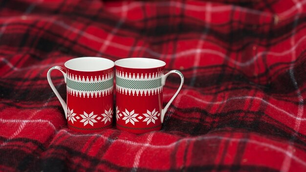 Two cups patterned stand on blankets