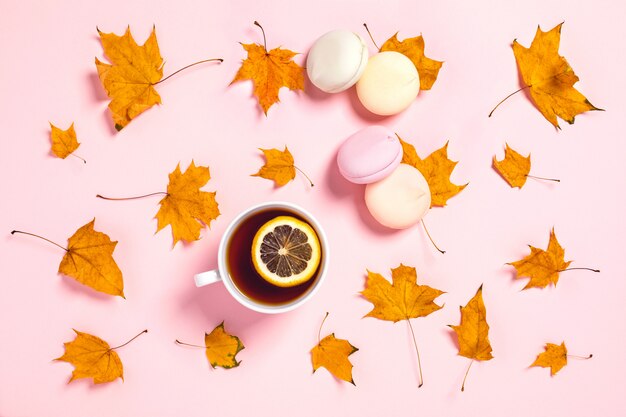 Two cups of tea with marshmallow and maple leaves.