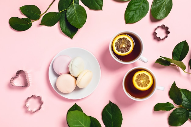 Two cups of tea with marshmallow and roses.