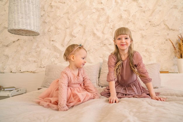 two cute caucasian sisters in pink portrait