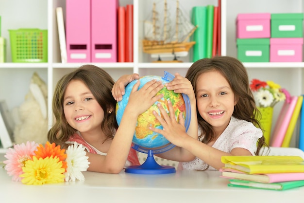 Two cute girls embracing Globe